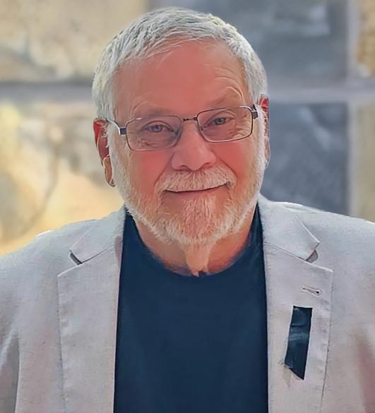 Edwin, smiling, grey jacket, black shirt
